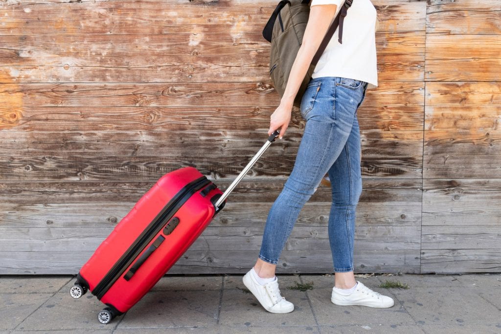 side view woman with her luggage 2 1 scaled